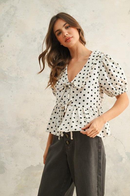 ELIZA POLKA DOT PEPLUM TOP IN CREAM