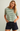 A woman modeling a short-sleeve crewneck t-shirt with green and off-white horizontal stripes, paired with dark denim shorts, against a plain light gray background.