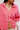 Woman wearing an oversized button front linen top.