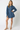 Woman wearing a denim dress on a white background