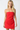 Woman wearing a strapless red dress against a white background