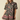 A woman modeling a short-sleeve button-up shirt dress with a dark green base and a pink, red, and beige floral pattern, set against a solid beige background.