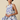 Woman wearing a floral dress with a beige background