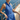 Woman in a blue romper on a yacht with ocean in the background