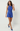 Woman wearing a blue romper on a white background