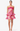 Woman wearing a pink floral dress on a white background