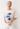 Woman wearing a beige oversized t-shirt with blue fish designs on a white background