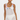 Woman wearing a white crochet dress with floral patterns on a white background