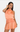 Woman wearing a peach halter top and skirt set on a white background