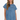 A woman modeling a light blue denim mini dress with short sleeves, a gathered neckline, and raw hems, set against a plain white studio background.