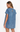 A woman wearing a light blue denim short-sleeve dress, shown from the back against a plain white studio background.