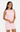 Woman wearing a light pink dress against a white background