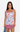 Woman wearing a sleeveless dress with a graphic pattern on a white background