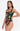 Woman wearing a black swimsuit with colorful tropical-themed designs on a white background