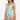 Woman wearing a green and white patterned swimsuit on a white background
