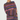 A woman modeling a chunky knit sweater dress with horizontal stripes in purple, blue, pink, and orange on a light gray background.