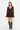 A model wearing a dark brown long-sleeve mini dress with ruffle details and matching brown knee-high boots, standing against a plain white studio background.