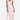 Woman wearing a light pink sleeveless gown on a white background