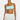 Woman wearing a light blue top and white crochet skirt on a plain background