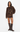 A woman modeling a brown and black tiger-print knit sweater dress with a large tiger face graphic on the front, paired with dark brown knee-high boots, against a plain white studio background.