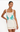 Woman wearing a white dress with palm tree and shell designs on a white background