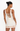 Woman wearing a white dress with cut-out back design on a white background