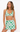 Woman wearing a green and white patterned bikini set on a white background
