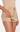 A close-up of a model wearing beige suede-like shorts with a zippered front and a draped side detail, paired with a matching beige ribbed top against a plain white background.