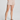 Person wearing a beige skirt on a plain background