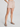 Person wearing a beige skirt on a plain background