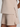 Beige shorts and top set on a plain background