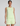 Woman wearing a light green sleeveless top and shorts set on a plain background