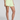 Person wearing light green shorts on a plain background