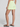 Person wearing a light green skirt on a plain background