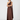 A woman modeling a floor-length, one-shoulder satin dress in a rich dark brown color, standing against a clean, light gray studio background.