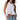Woman wearing a white halter top and denim shorts on a white background