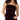 A woman wearing a dark plum velvet strapless tube top and matching velvet pants against a plain white background.