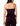 Rear view of a woman wearing a strapless dark plum velvet corset-style top with a peplum hem and matching velvet pants against a white studio background.