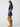 Woman wearing a denim outfit with a white background