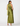 A woman modeling a sleeveless olive green halter maxi dress with white polka dots, shown from the back against a plain white studio background.