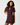 A woman modeling a short-sleeve bodycon mini dress in deep burgundy with a keyhole cutout at the neckline, set against a plain light gray studio background.