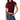 A woman wearing a ruched short-sleeve crop top in deep burgundy with sheer mesh shoulder panels, paired with blue jeans, against a plain white background.