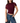 A woman wearing a ruched short-sleeve crop top in deep burgundy with sheer mesh shoulder panels, paired with blue jeans, against a plain white background.