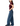 A woman shown in side profile wearing a fitted burgundy short-sleeve top and wide-leg blue jeans against a plain white studio background.