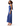 A woman modeling a satin-like sleeveless maxi dress in a medium blue shade, shown from the side against a plain white studio background.