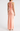 Peach-colored halter neck gown on a white background