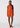 Woman wearing an orange dress with a white pattern on a white background