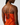Orange dress with thin straps and button details on a plain background