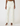 White pants with a subtle pattern worn by a model on a white background