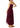 A woman modeling a burgundy maxi dress with spaghetti straps, a fitted bodice, and a sheer lace hem, shown from the back against a plain white background.
